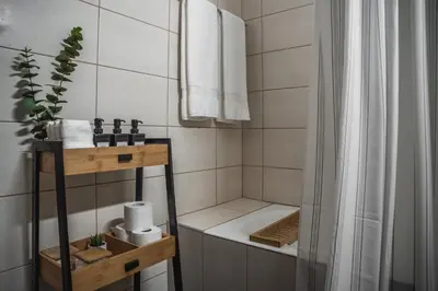 a bathroom with a shower and a bath tub at Creative 1br Pool view Apt with covered parking in Livadhia