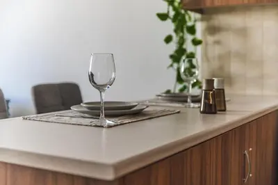 a wine glass sitting on top of a kitchen counter at Creative 1br Pool view Apt with covered parking in Livadhia