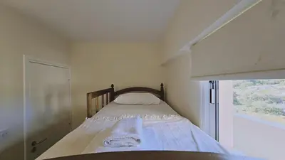 a bed in a small room with a window at Nissi Golden Sands Privileges Apt in Ayia Napa