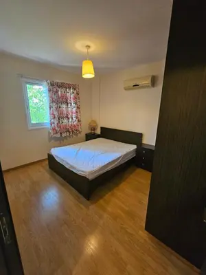 a bedroom with a bed and a window at STEFARIS sea & mountain view in Larnaka