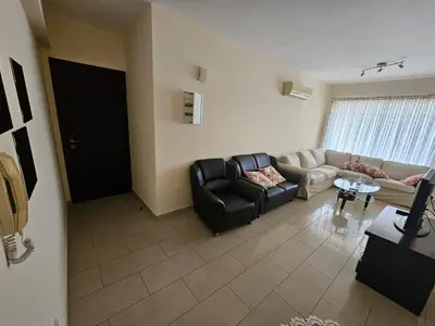 a living room with a couch and a table at STEFARIS sea & mountain view in Larnaka