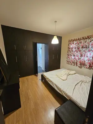 a bedroom with a bed and a painting on the wall at STEFARIS sea & mountain view in Larnaka