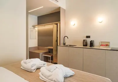 a kitchen with white towels sitting on a table at Alinea Market Agora Square in Limassol