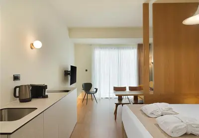 a kitchen and living room with a bed and a table at Alinea Market Agora Square in Limassol