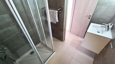 a bathroom with a shower and a sink at City Center: Your Urban Retreat- 100m to the beach in Larnaka