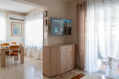 a living room with a television on top of a dresser at Apartment Kamilla- Kaparis in Paralimni
