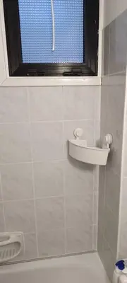 a bathroom with a window and a sink on the wall at Sea-side City centre Studio in Larnaka