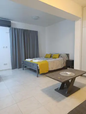 a bedroom with a bed and a table in it at Sea-side City centre Studio in Larnaka