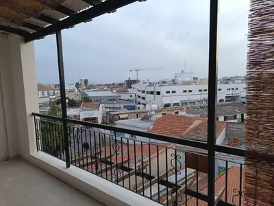 a balcony with a view of a city at Sea-side City centre Studio in Larnaka