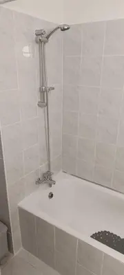 a bath tub with a shower in a bathroom at Sea-side City centre Studio in Larnaka