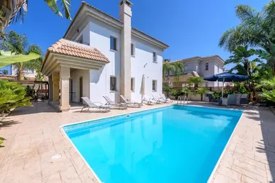 a swimming pool in front of a villa at Alex Villa Kapparis in Protaras
