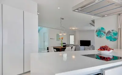 a kitchen and dining room with white walls and a table at Sea Pearl Seaview Villa - Oriana in Ayia Napa