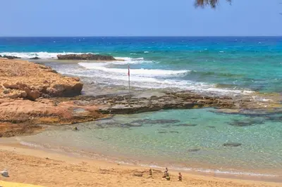 a group of people standing on a beach near the ocean at Sea Pearl Seaview Villa - Oriana in Ayia Napa