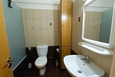 a bathroom with a toilet and a sink and a mirror at Maestro III Apartment in Larnaka