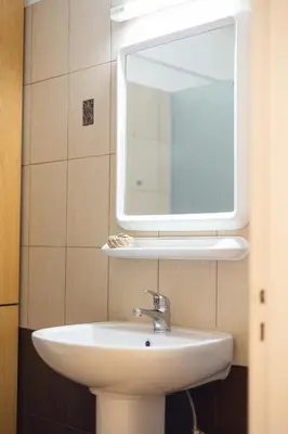 a bathroom with a sink and a mirror at Maestro III Apartment in Larnaka