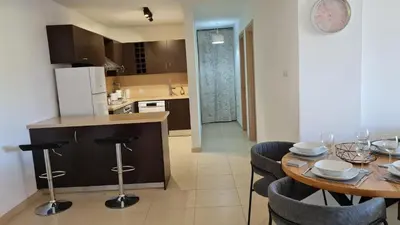 a kitchen and dining room with a table and chairs at The Olive Grove Escape, Eleonas Apts in Sotira