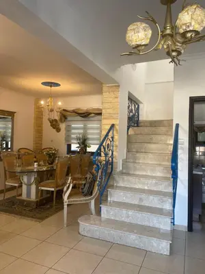 a staircase in a restaurant with a table and chairs at House of Hera in Livadhia