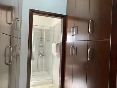 a bathroom with a shower and a glass door at House of Hera in Livadhia