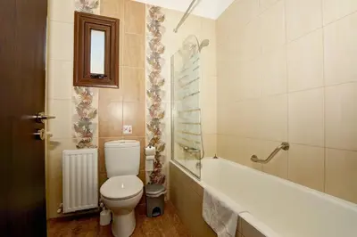 a bathroom with a toilet and a bath tub at Seafront Protaras Villas in Protaras