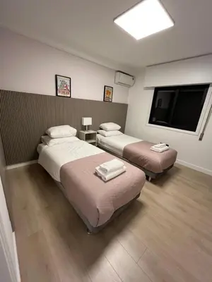 a hotel room with two beds and a flat screen tv at Modern 2bed in the centre in Nicosia