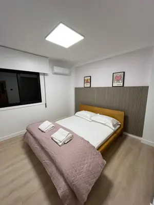 a bedroom with a bed with two towels on it at Modern 2bed in the centre in Nicosia