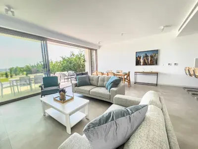 a living room with two couches and a table at Azure Vista Collection in Protaras