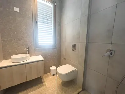 a bathroom with a toilet and a sink and a shower at Azure Vista Collection in Protaras