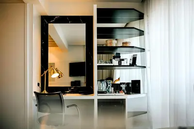 a desk with a mirror and a chair in a room at The Ciao Stelio Deluxe Boutique Hotel - Adults Only in Larnaka