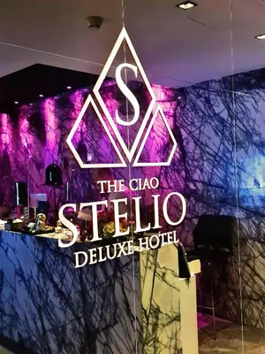a neon sign for the club stella deluxe hotel at The Ciao Stelio Deluxe Boutique Hotel - Adults Only in Larnaka
