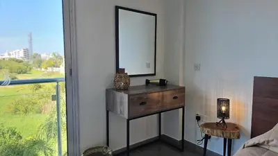 a bedroom with a dresser and a mirror on a wall at STAY White Coral Studio in Protaras