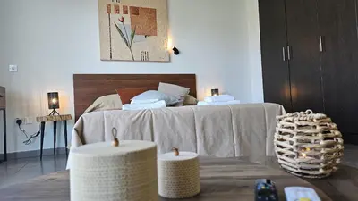 a bedroom with a bed and two candles on a table at STAY White Coral Studio in Protaras
