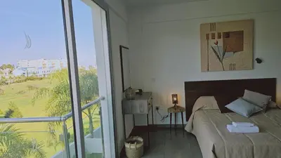 a bedroom with a bed and a large window at STAY White Coral Studio in Protaras