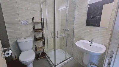 a bathroom with a shower and a toilet and a sink at STAY White Coral Studio in Protaras