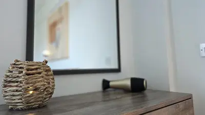 a vase sitting on top of a wooden table at STAY White Coral Studio in Protaras