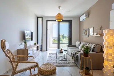 a living room with a couch and a table at Ivory 1-BR Apartment in Aradipou in Aradhippou