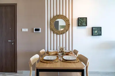 a dining room with a table with chairs and a mirror at Ivory 1-BR Apartment in Aradipou in Aradhippou