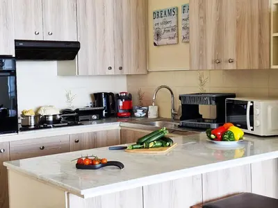 a kitchen with a counter with fruits and vegetables on it at Makenzy Sandy Beachfront Paradise in Larnaka