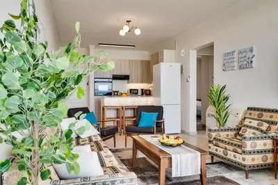 a living room with two chairs and a coffee table at Makenzy Sandy Beachfront Paradise in Larnaka