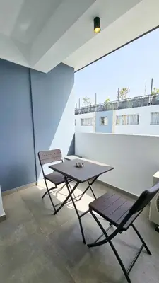 a table and two chairs in a room at Sealife Citycenter Residences in Larnaka