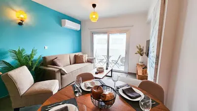 a living room with a table and chairs at Sealife Citycenter Residences in Larnaka