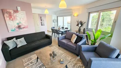 a living room with two couches and a table at Sealife Citycenter Residences in Larnaka