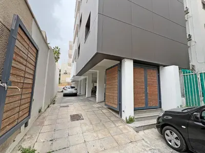 a car parked in front of a building at Albert's Apartment Center 202B in Larnaka