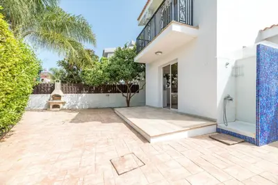 a white house with a courtyard with a fountain at Thekla Oasis Villa in Ayia Napa