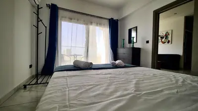 a bedroom with a large bed with a large window at 351 Turquoise Oasis in Limassol