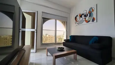 a living room with a couch and a large window at 351 Turquoise Oasis in Limassol