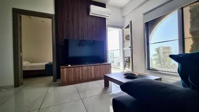 a living room with a couch and a flat screen tv at 351 Turquoise Oasis in Limassol