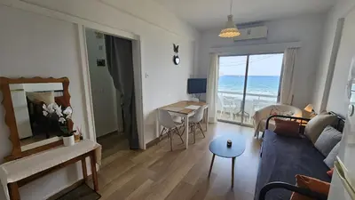 a living room with a couch and a table at STAY Dreamy Seaside Apartment in Larnaka