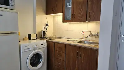 a kitchen with a washing machine and a sink at STAY Dreamy Seaside Apartment in Larnaka