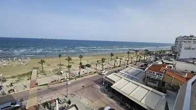 a view of a beach with the ocean and buildings at STAY Dreamy Seaside Apartment in Larnaka