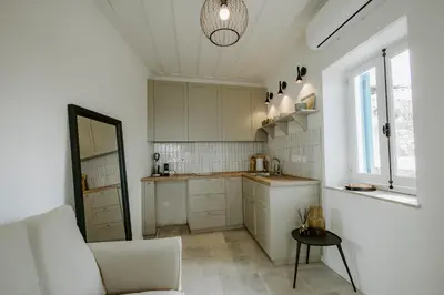 a kitchen with a couch and a table in a room at Smaragda's Guest Rooms in Limassol